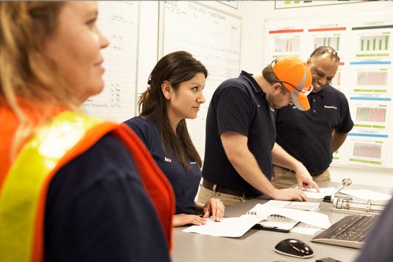 Purina manufacturing workers reviewing paperwork
