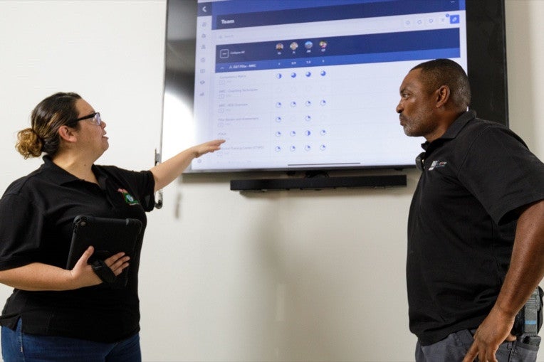Associates reviewing a training dashboard