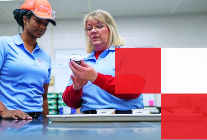 Purina workers checking canned food