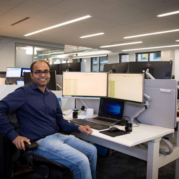 Man smiling in his chair at work