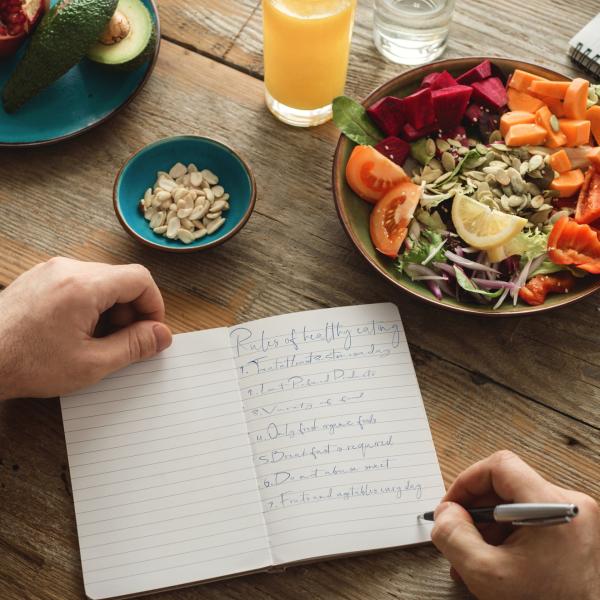 Someone eating a snack with a notebook