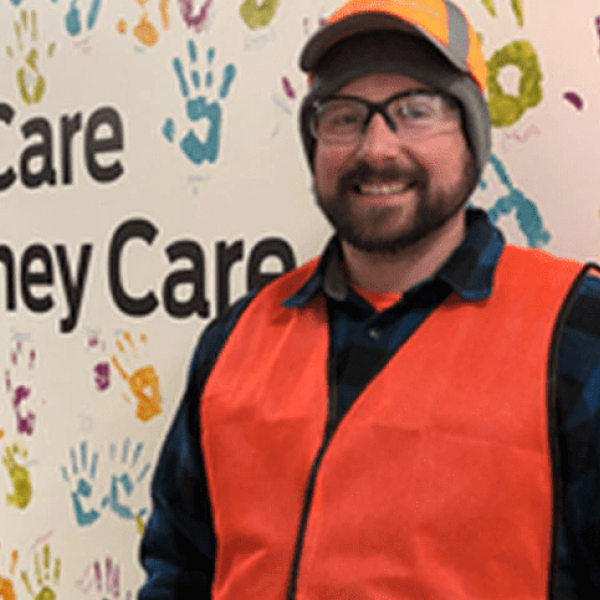 Nestlé Purina employee posing in front of a mural