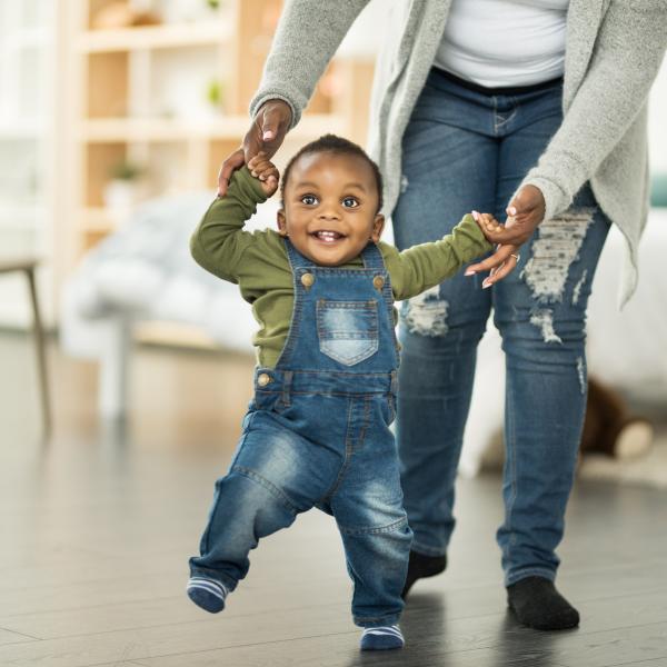 Baby walking with his parent
