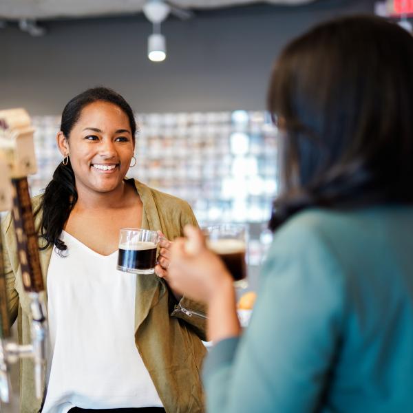 two nestle employees drinking coffee