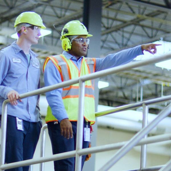 Young worker being trained by veteran employee