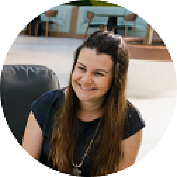 woman sitting with iPad smiling