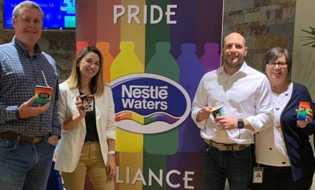 Nestlé employees smiling at the camera  