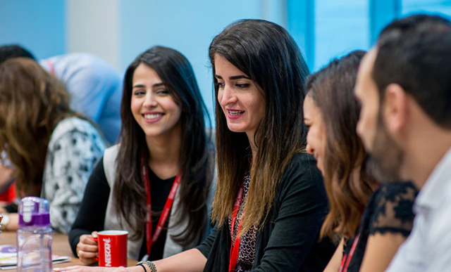 Nestlé employees smiling at the camera  