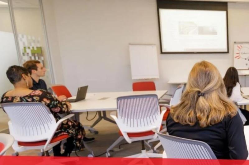 Associates sit in the Associate Development Center for a live training