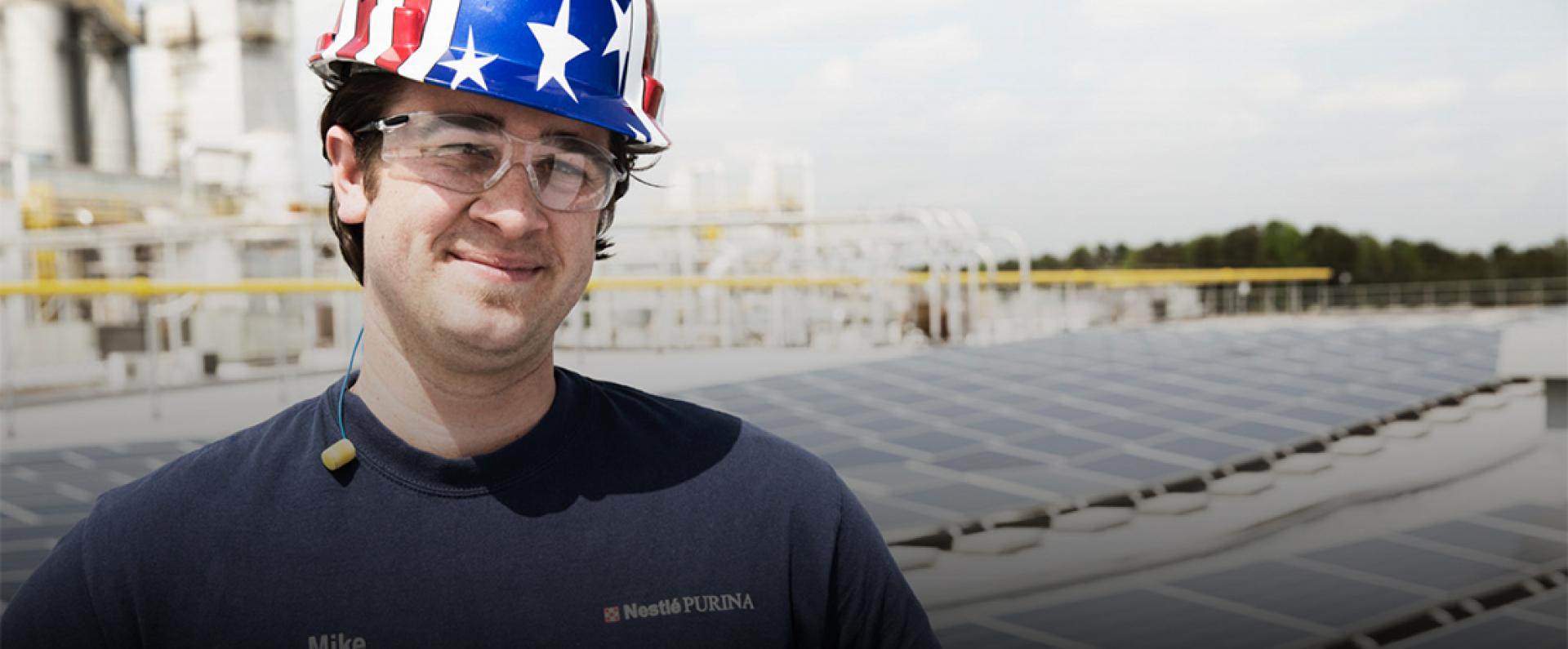 Man smiling at the camera wearing an American Flag helmet