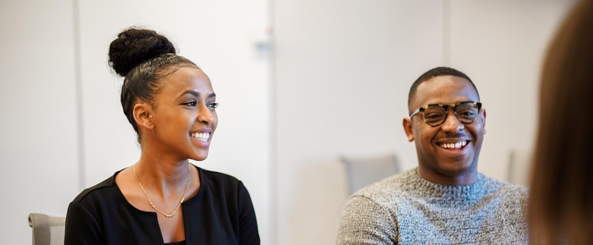 Two Nestlé associates laughing and smiling