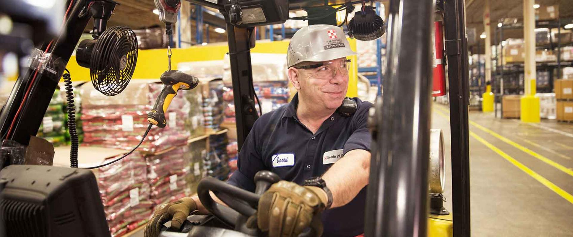 Purina associate driving a forklift