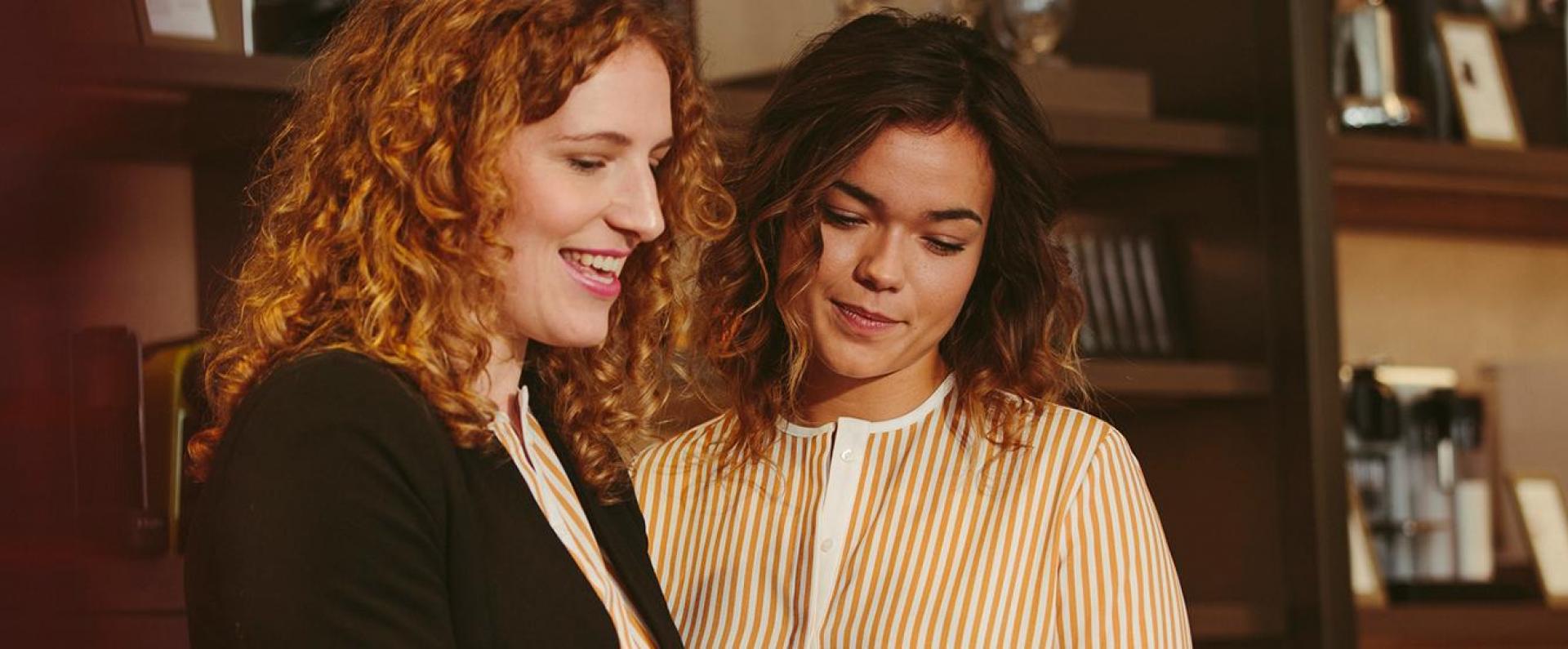 Employees talking and smiling at each other