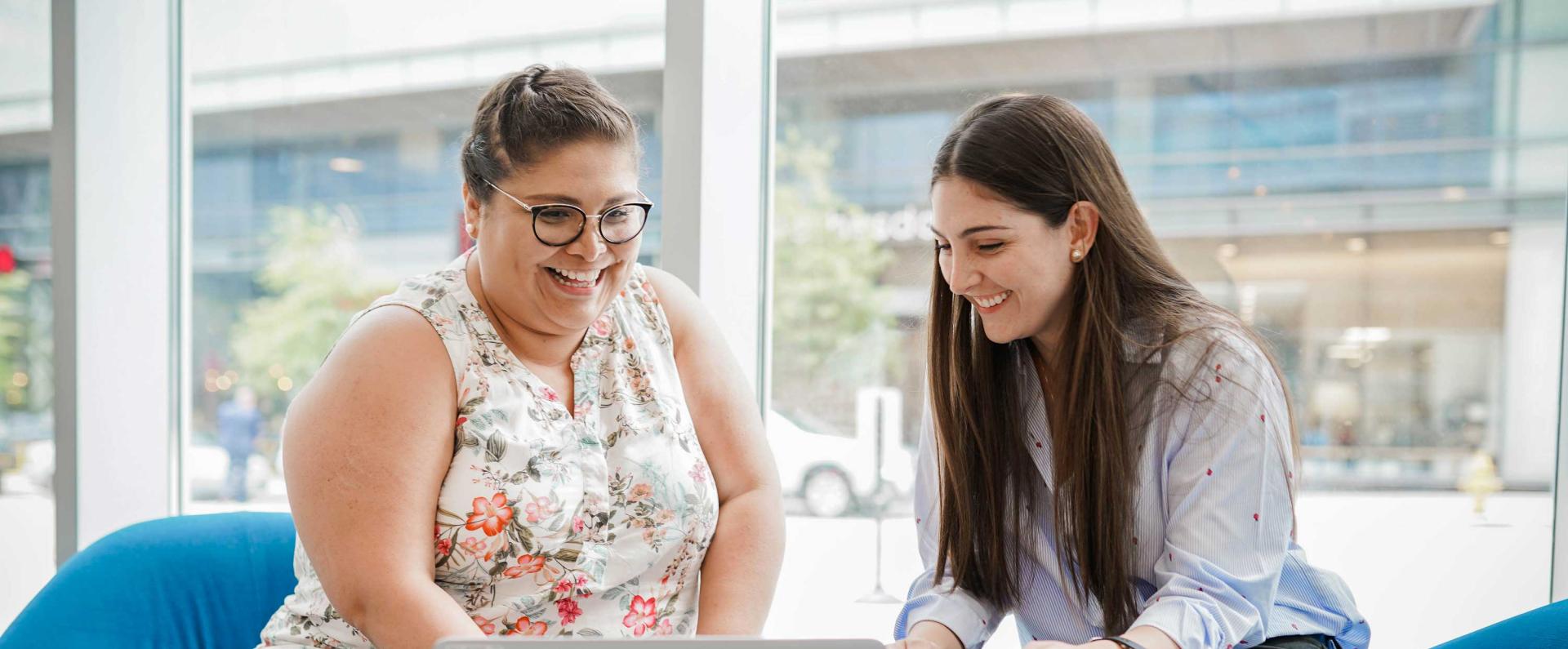 Two female employees collaborating in the office