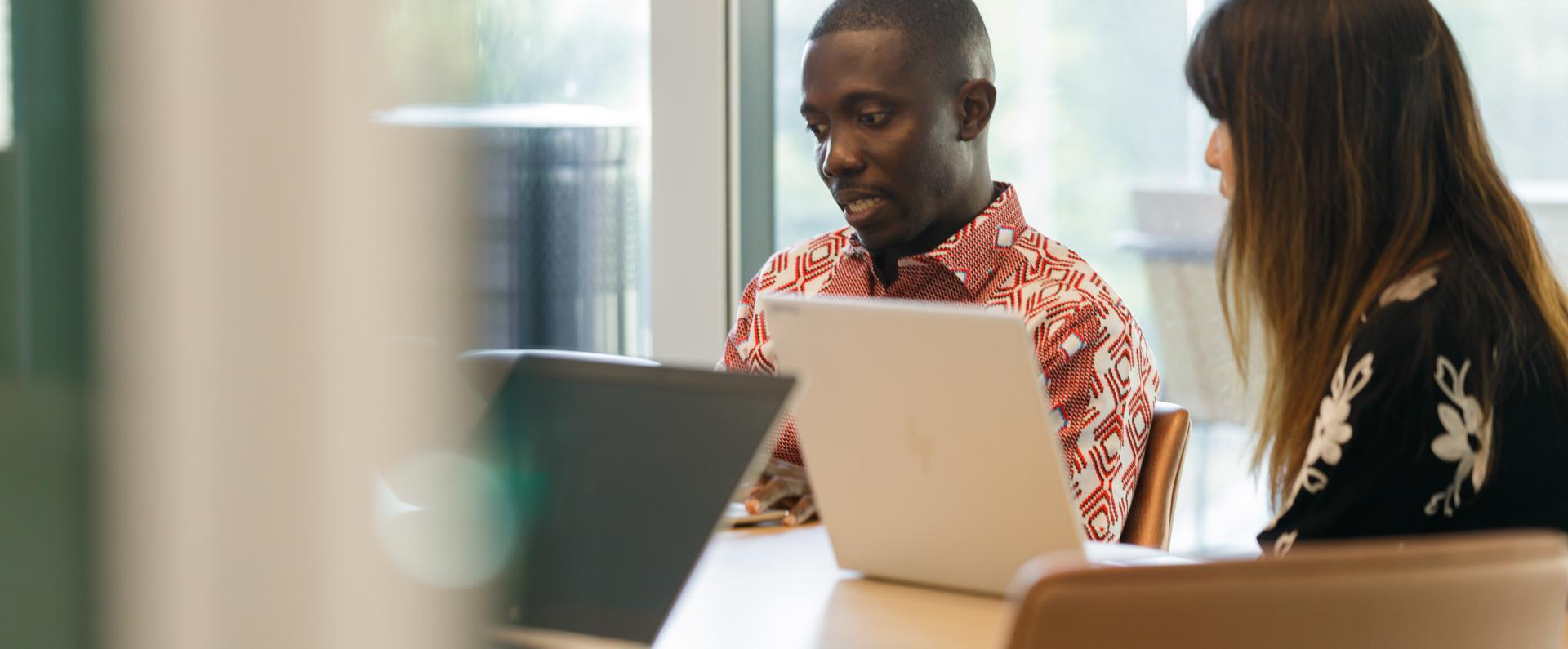 man and woman sitting at desk