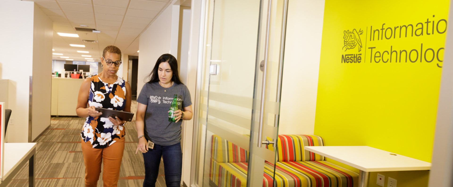 women walking down hallway