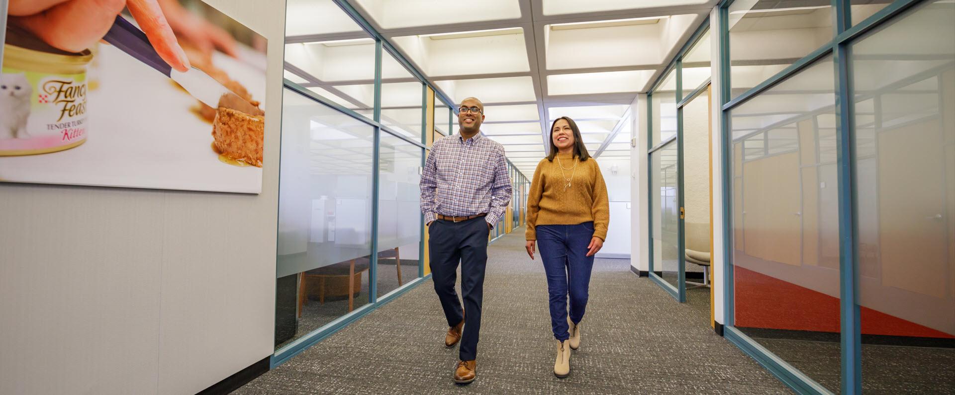 Man and woman talking down hallway