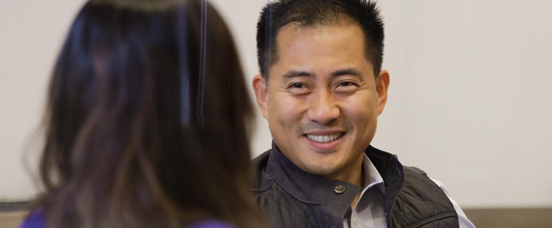 Two employees smiling during meeting