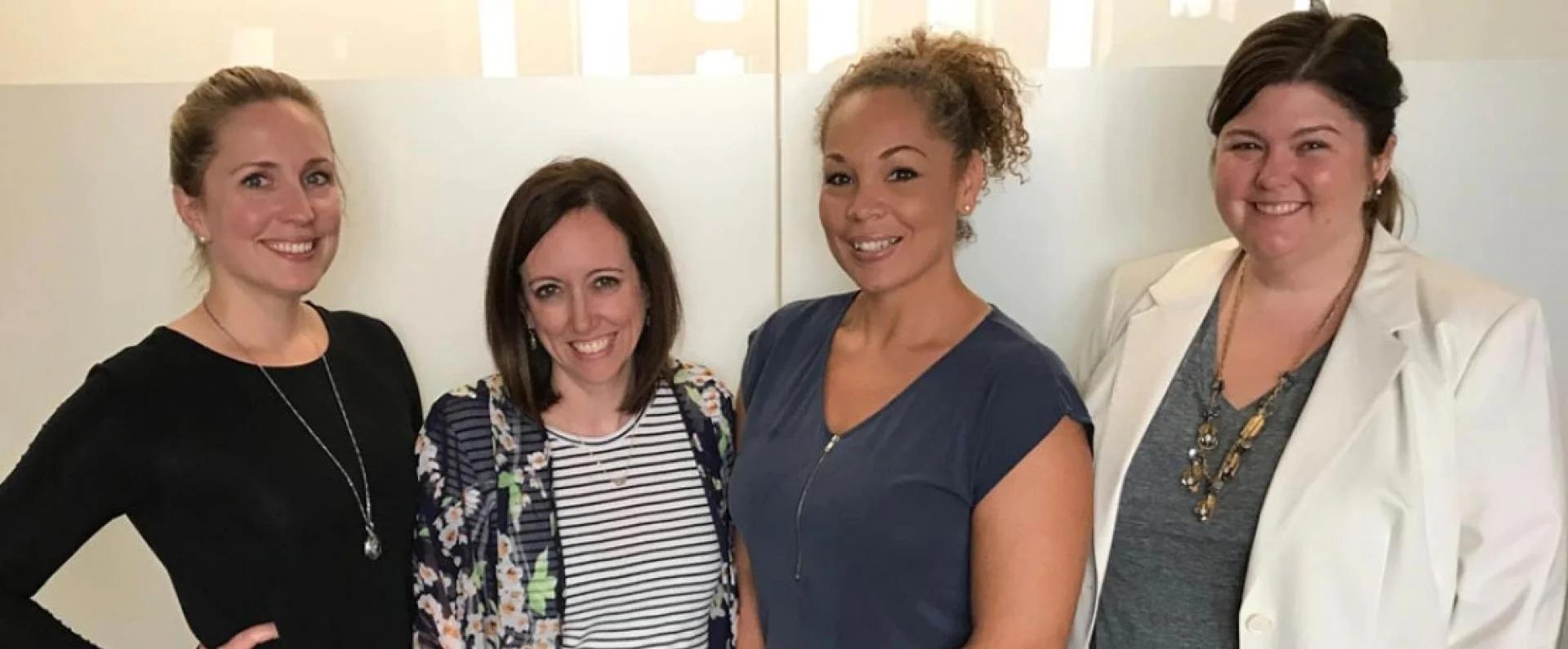 4 women outside a conference room