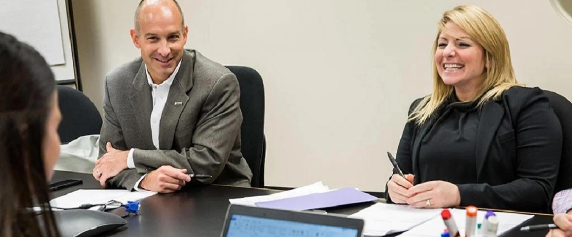 Employees smiling in conference room