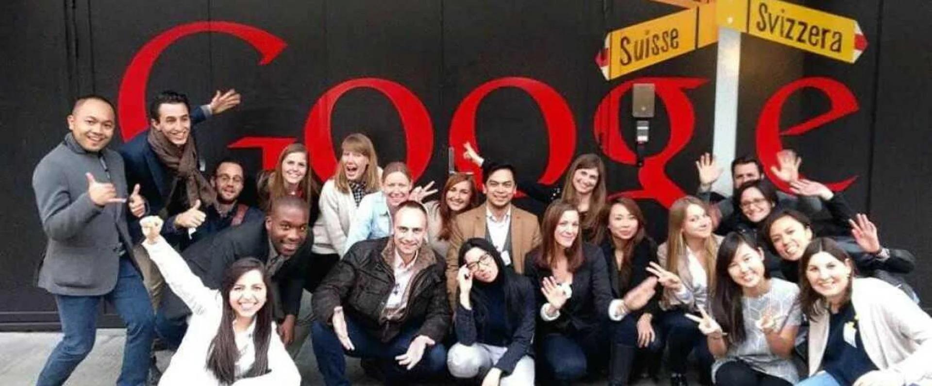 A group of smiling people in front of Google office