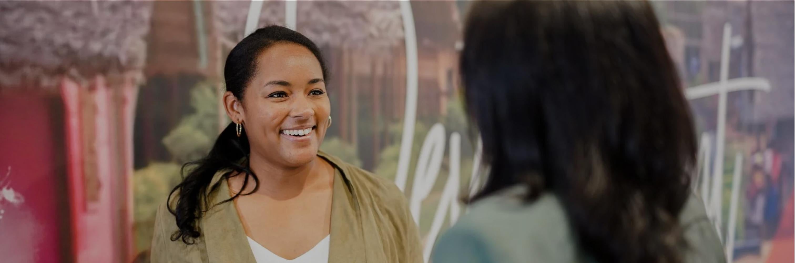 Two Nestle employees talking with one another