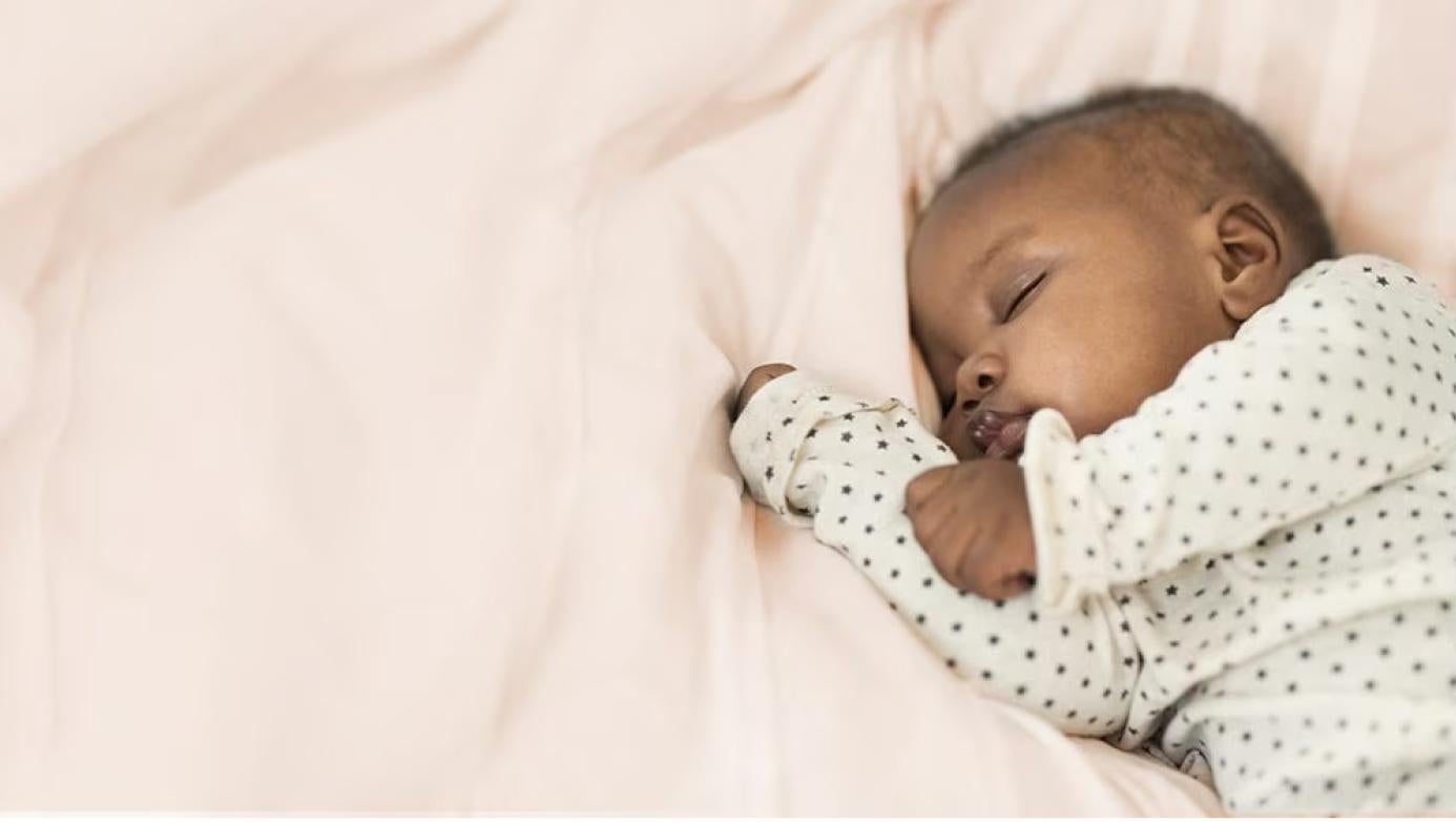 baby sleeping on a bed