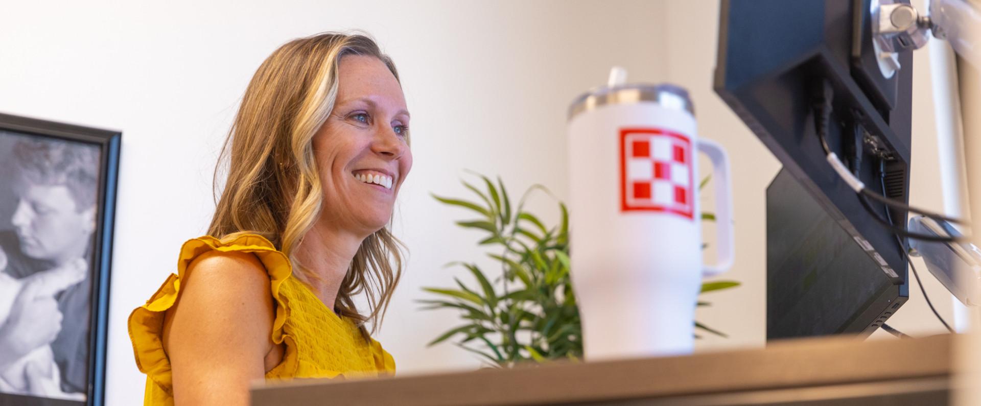 Woman smiling while working at home